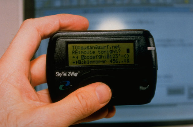 Hand holding SkyTel 2-Way alphanumeric 